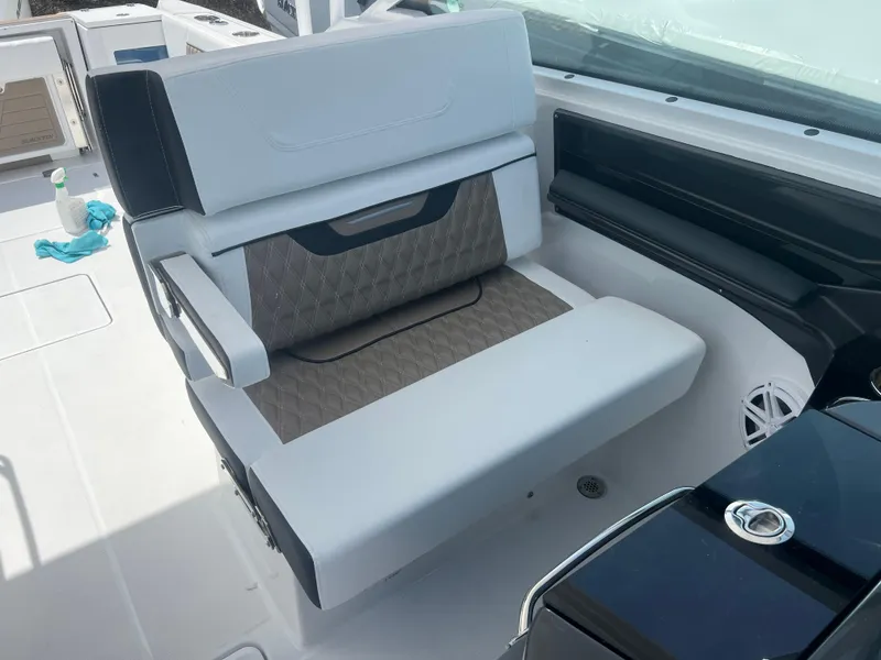 Slide: The Image of 2024 Blackfin 272DC boat interior seating with white and gray upholstery. - 19