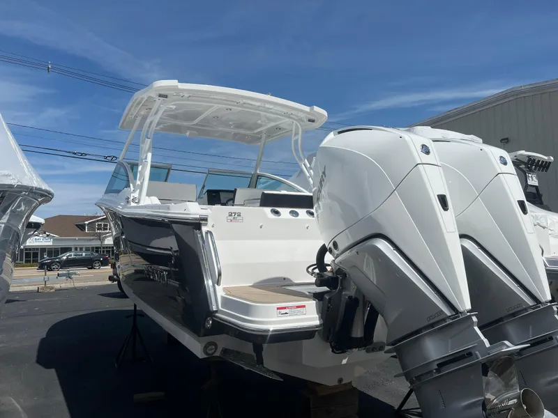Slide: The Image of 2024 Blackfin 272DC boat with twin outboard engines on display. - 2
