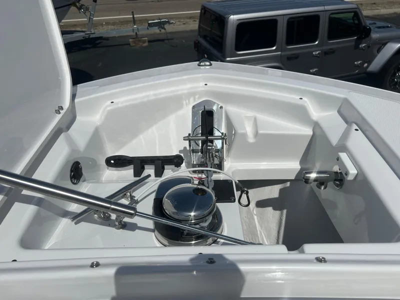 Slide: The Image of 2024 Blackfin 272DC boat anchor compartment with winch and cleats. - 23