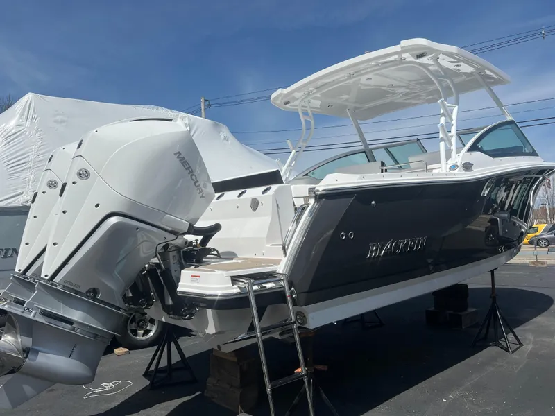 Slide: The Image of 2024 Blackfin 272DC boat with twin Mercury outboard engines on display. - 3