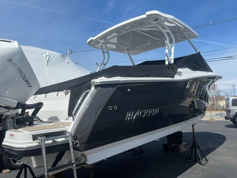 Slide: The Image of 2024 Blackfin 272DC boat with Mercury engine, docked on a trailer. - 5