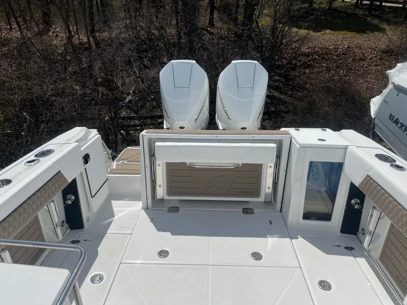 Slide: The Image of 2024 Blackfin 272DC boat with dual outboard engines, rear deck view. - 8