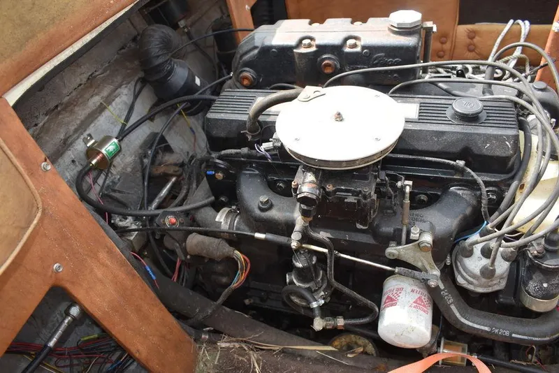 Slide: The Image of 1983 Rinker 204 Cuddy Cabin engine compartment with visible components and wiring. - 11
