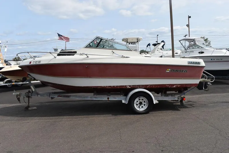 Slide: The Image of 1983 Rinker 204 Cuddy Cabin boat on trailer, parked outdoors. - 2