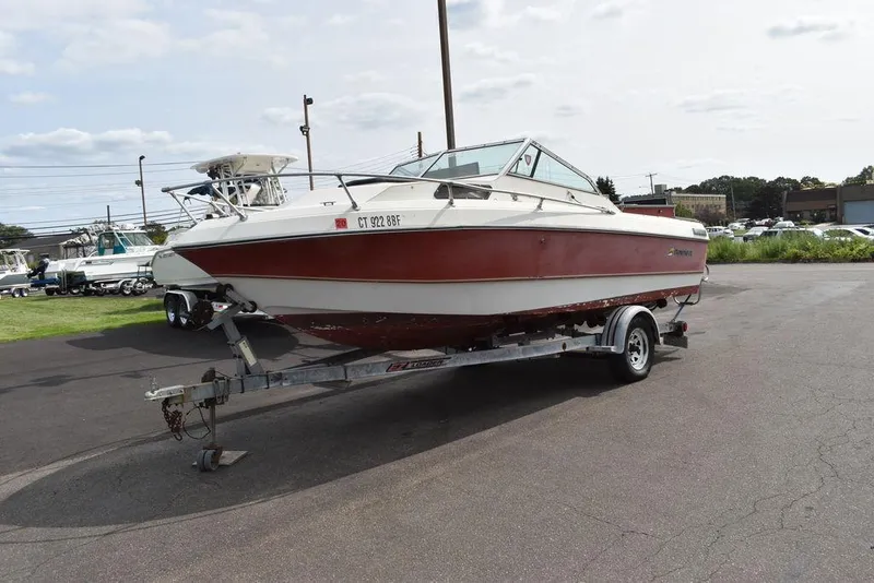 Slide: The Image of 1983 Rinker 204 Cuddy Cabin boat on trailer, parked outdoors. - 3