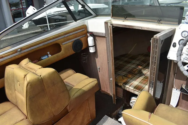 Slide: The Image of Interior of 1983 Rinker 204 Cuddy Cabin boat with vintage seating and cabin area. - 6