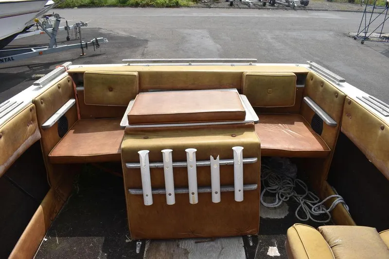 Slide: The Image of 1983 Rinker 204 Cuddy Cabin interior with vintage seating and fishing rod holders. - 8