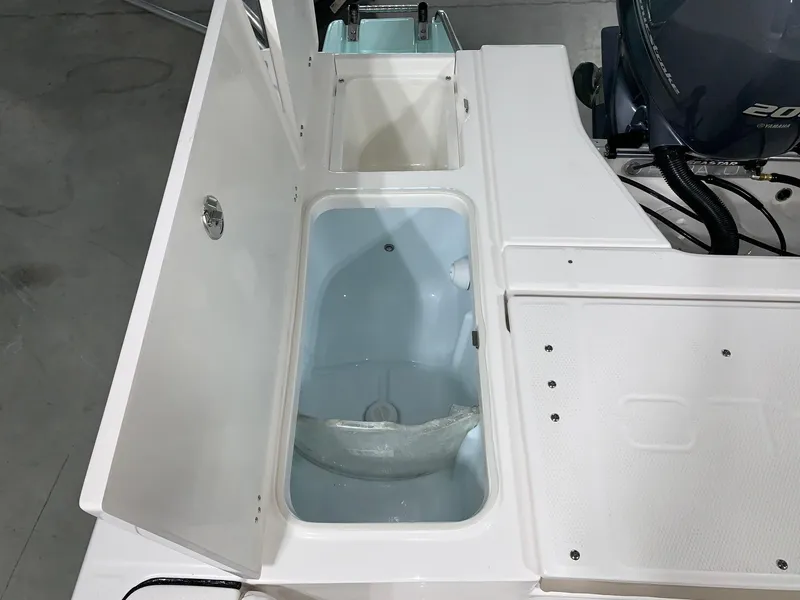 Slide: The Image of 2026 Robalo 226 Cayman boat storage compartments and engine view. - 10