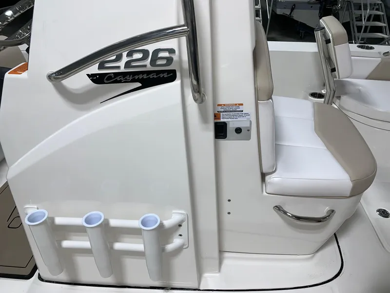 Slide: The Image of 2026 Robalo 226 Cayman boat interior with seating and rod holders. - 19