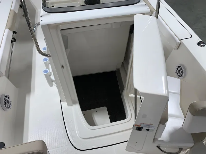 Slide: The Image of 2026 Robalo 226 Cayman boat interior storage compartment with open hatch and seating area. - 20