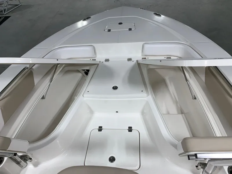 Slide: The Image of 2026 Robalo 226 Cayman boat interior with storage compartments and seating. - 23