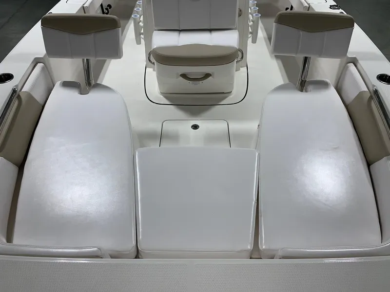 Slide: The Image of 2026 Robalo 226 Cayman boat interior with white seating and storage compartments. - 28