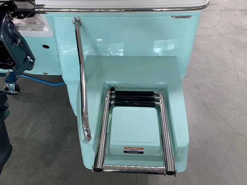 Slide: The Image of 2026 Robalo 226 Cayman boat with a retractable swim ladder and stainless steel handrail. - 5