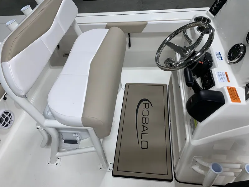 Slide: The Image of 2026 Robalo 226 Cayman boat interior with steering wheel and seating area. - 18