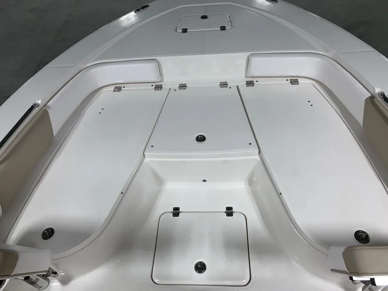 Slide: The Image of 2026 Robalo 226 Cayman boat deck with storage compartments and seating. - 26