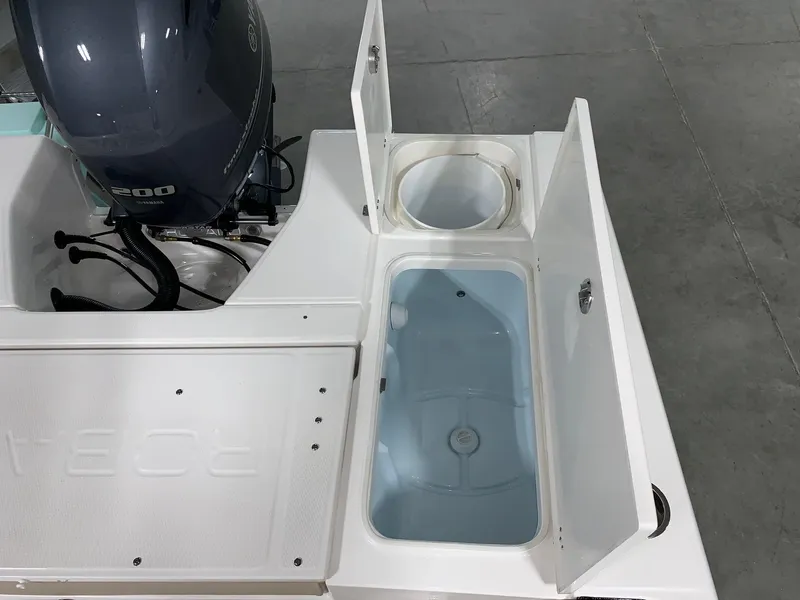 Slide: The Image of 2026 Robalo 226 Cayman boat with open storage compartments and outboard motor. - 9