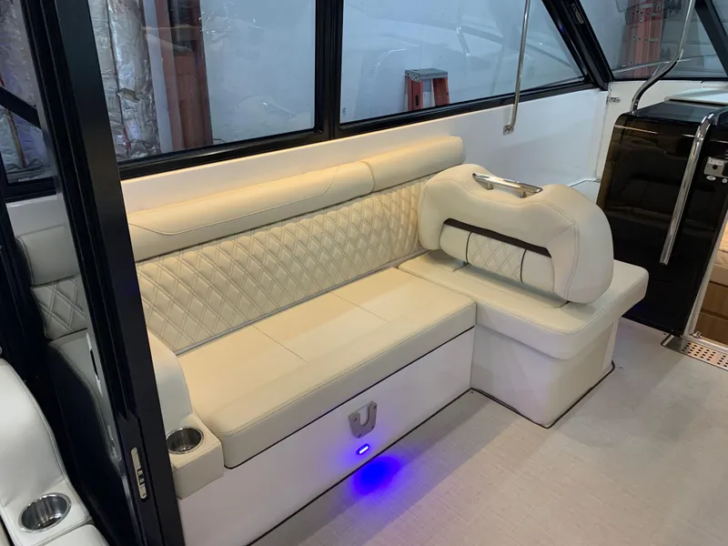 Slide: The Image of Luxurious seating area inside 2023 Regal 36XO boat with ambient lighting. - 11