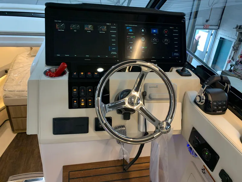 Slide: The Image of 2023 Regal 36XO boat helm with modern controls and touchscreen display. - 13