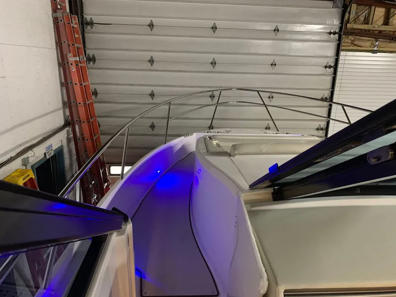 Slide: The Image of 2023 Regal 36XO yacht in indoor storage with blue LED lighting. - 16