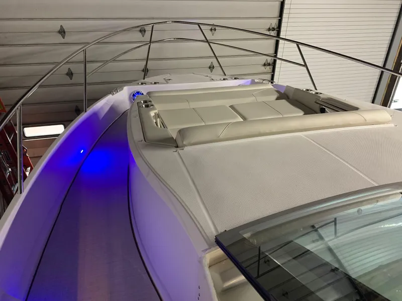 Slide: The Image of 2023 Regal 36XO boat with blue LED lights and cushioned seating. - 17