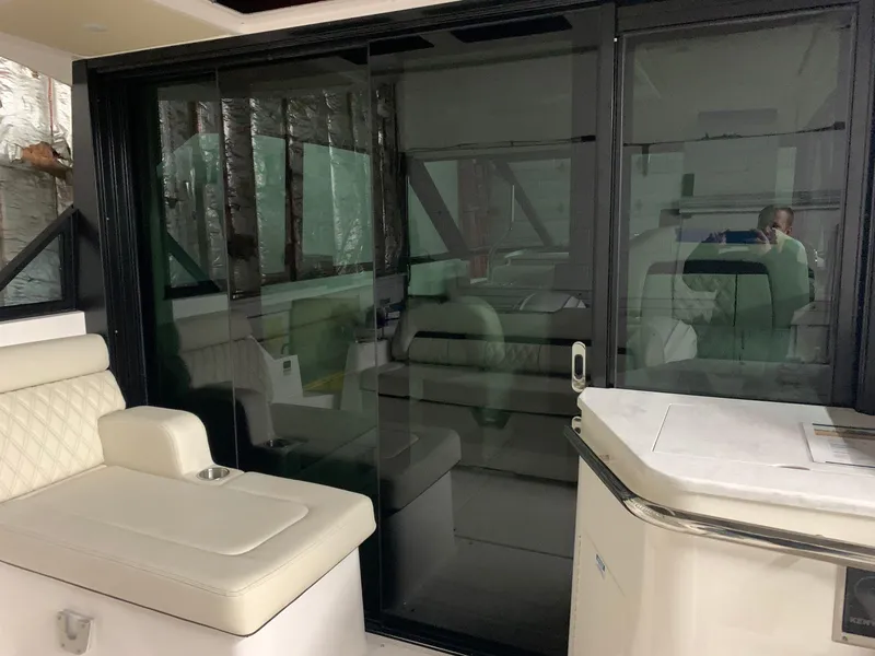 Slide: The Image of 2023 Regal 36XO yacht interior with sliding glass doors and white seating. - 3