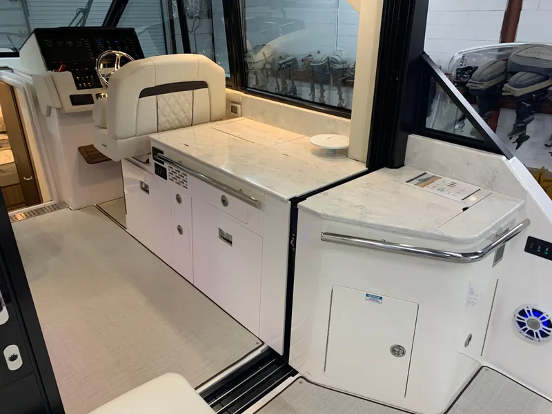 Slide: The Image of Interior of 2023 Regal 36XO yacht with modern helm and galley area. - 7