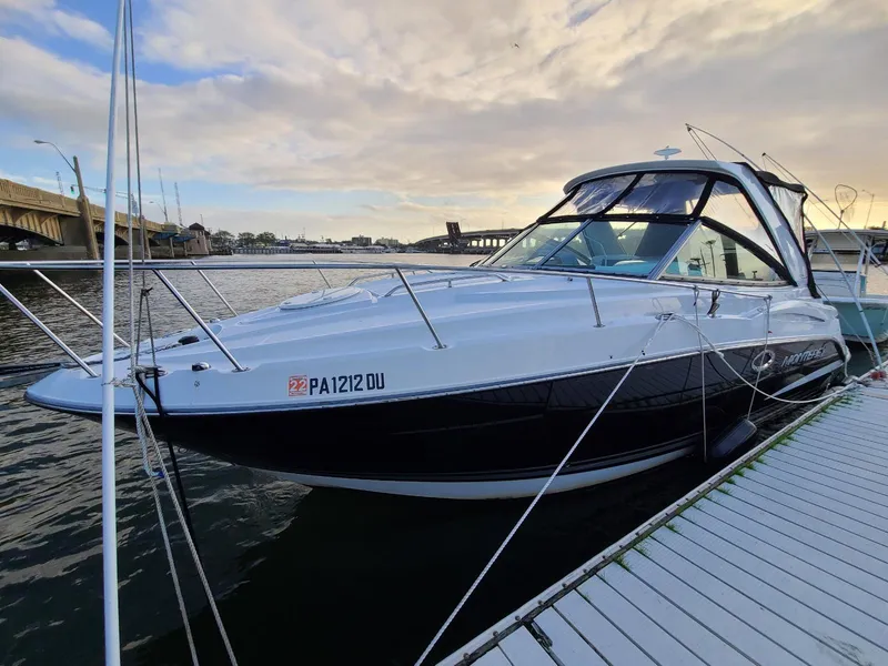 Slide: The Image of 2018 Monterey 295 Sport Yacht docked by a scenic waterfront. - 1