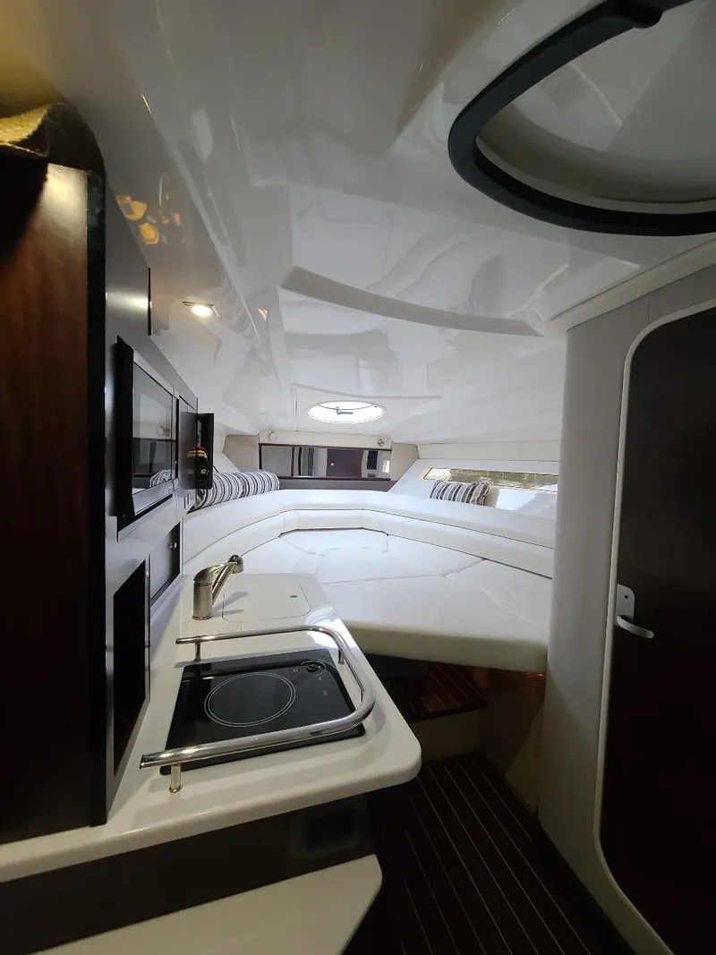 Slide: The Image of Interior of 2018 Monterey 295 Sport Yacht with kitchenette and cozy sleeping area. - 14