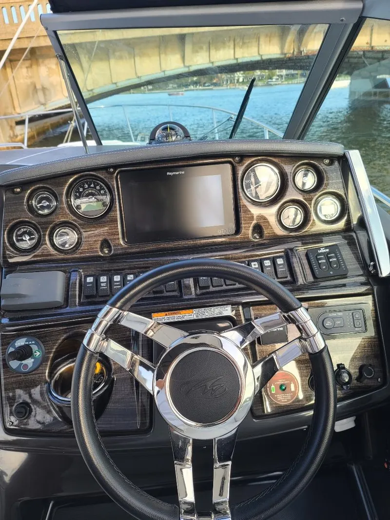 Slide: The Image of 2018 Monterey 295 Sport Yacht dashboard with steering wheel and control panel. - 15