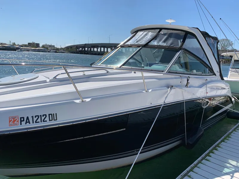Slide: The Image of 2018 Monterey 295 Sport Yacht docked by the water on a sunny day. - 3