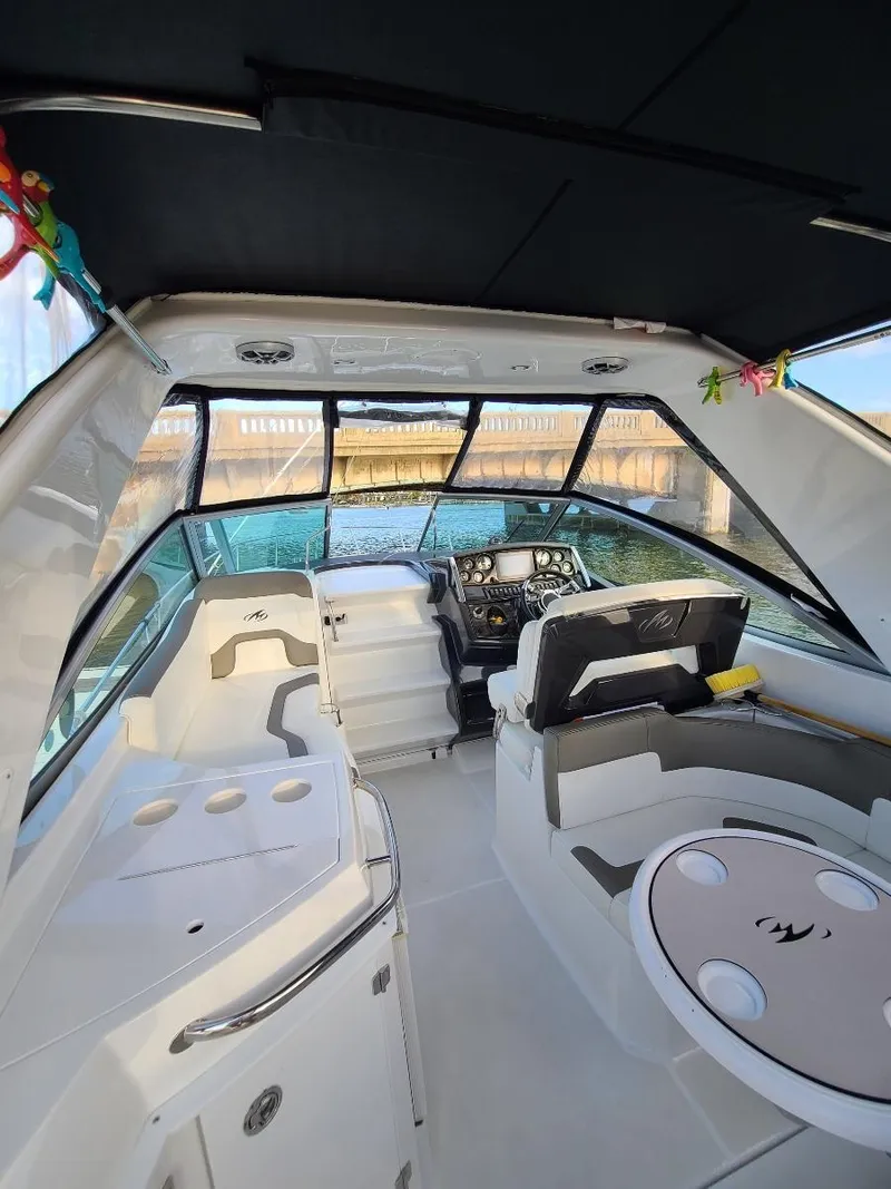Slide: The Image of Interior of 2018 Monterey 295 Sport Yacht, featuring helm and seating area. - 5