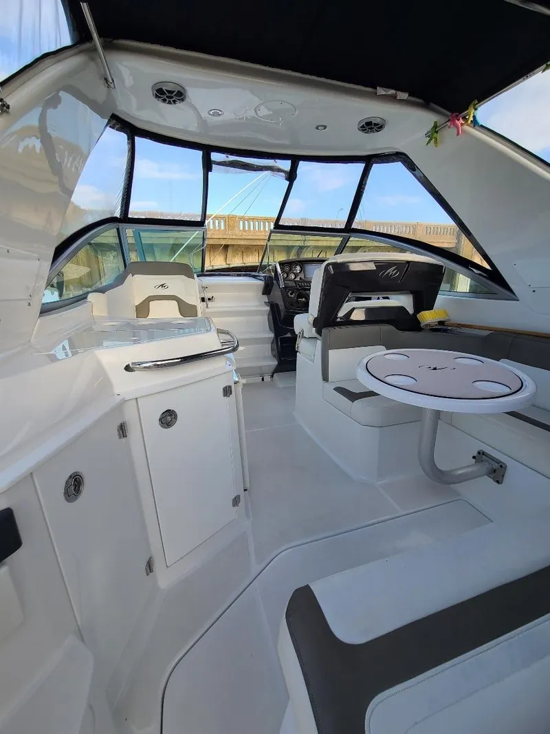 Slide: The Image of Interior of 2018 Monterey 295 Sport Yacht with modern seating and helm. - 6
