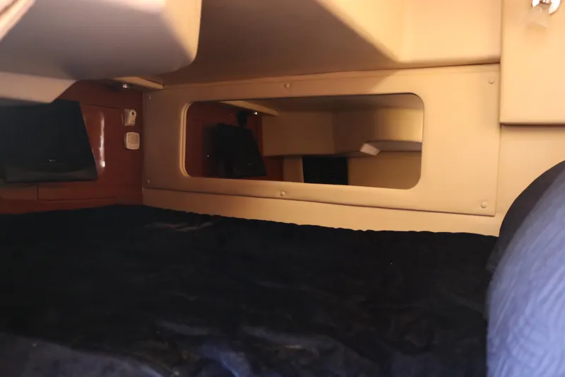 Slide: The Image of 2009 Regal 3060 Express Cruiser cabin interior with beige and wood accents. - 12