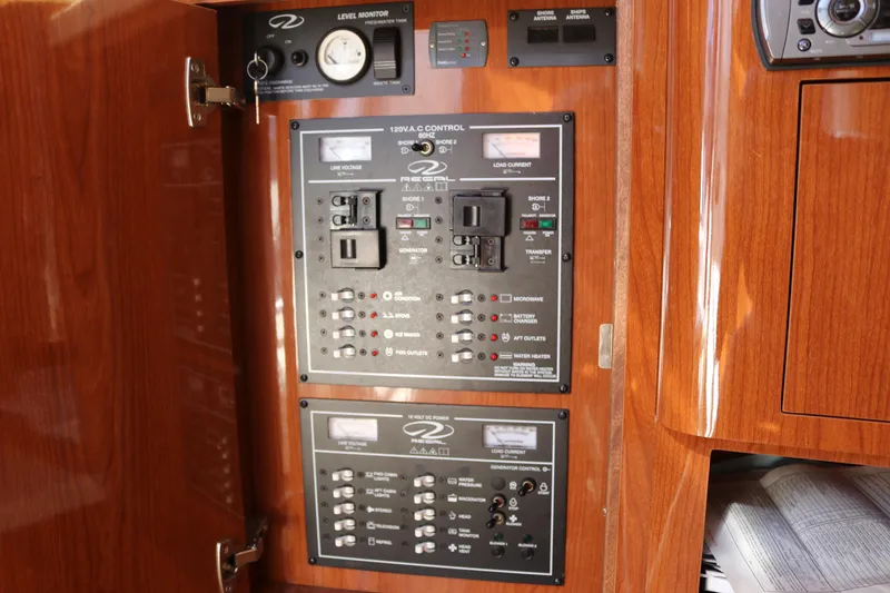 Slide: The Image of Electrical control panel inside 2009 Regal 3060 Express Cruiser, featuring switches and gauges. - 14