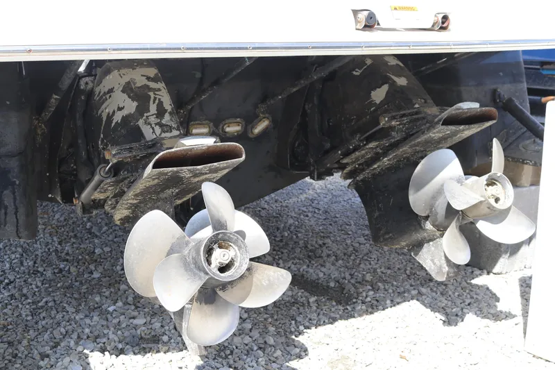 Slide: The Image of Propellers of a 2009 Regal 3060 Express Cruiser on gravel surface. - 2