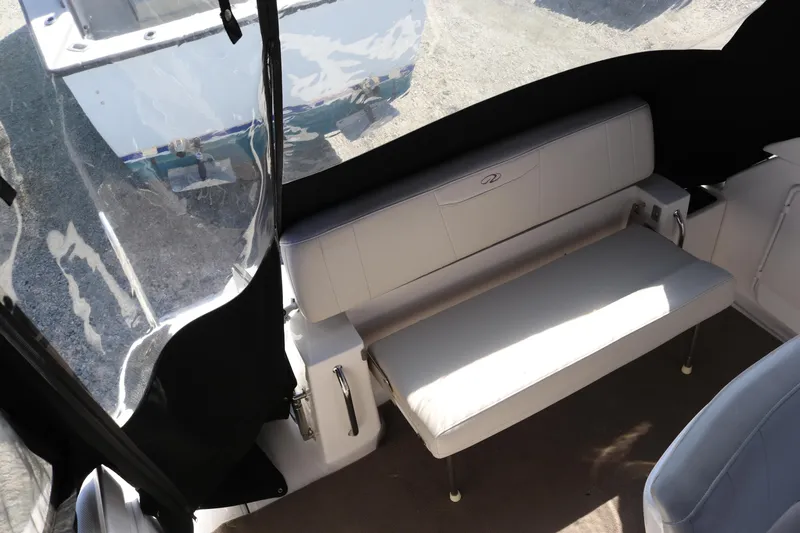 Slide: The Image of 2009 Regal 3060 Express Cruiser interior with white seating and protective cover. - 3