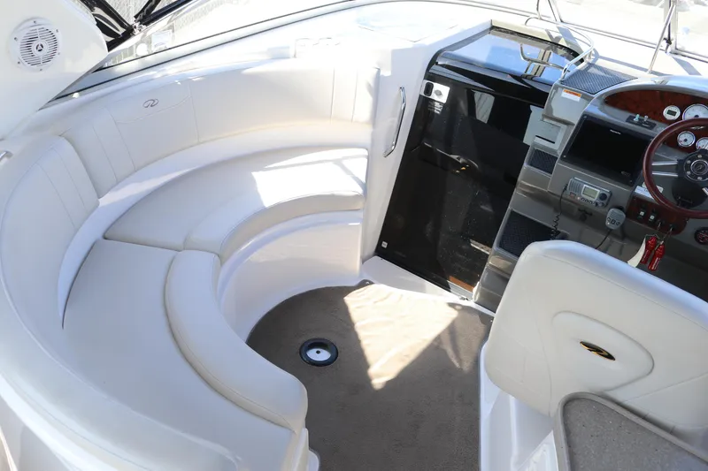 Slide: The Image of 2009 Regal 3060 Express Cruiser interior with curved seating and modern dashboard. - 4