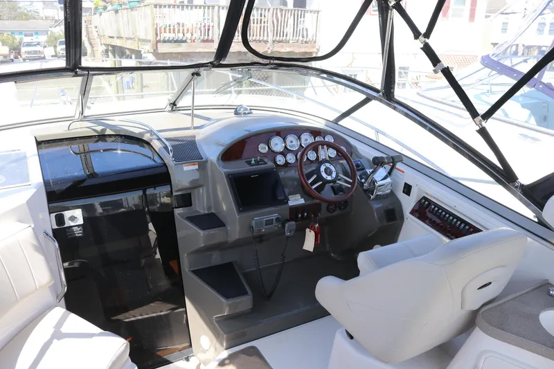 Slide: The Image of 2009 Regal 3060 Express Cruiser cockpit with steering wheel and control panel. - 5