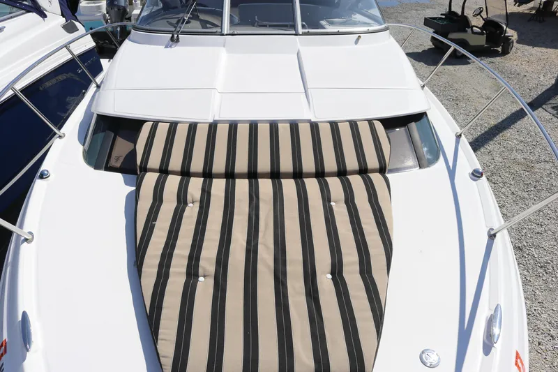 Slide: The Image of 2009 Regal 3060 Express Cruiser with striped sun pad on deck. - 8
