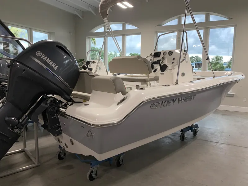 Slide: The Image of 2024 Key West 189 FS boat with Yamaha outboard motor in showroom. - 2