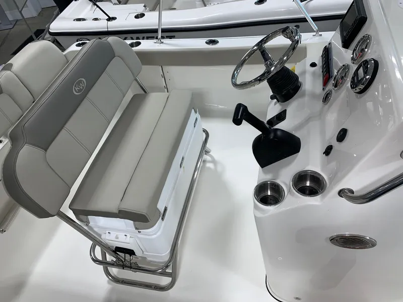 Slide: The Image of 2024 Key West 189 FS boat interior with steering console and cushioned seating. - 10