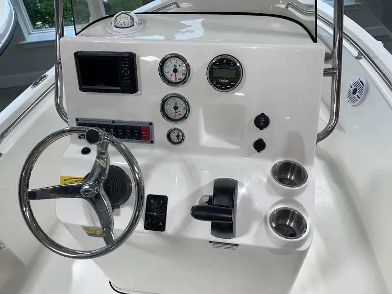 Slide: The Image of 2024 Key West 189 FS boat console with steering wheel, gauges, and controls. - 9