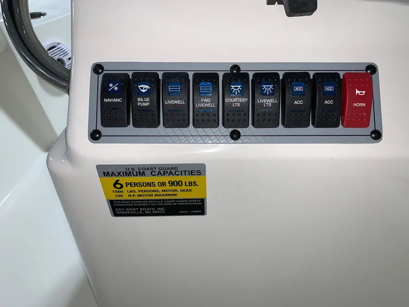 Slide: The Image of Control panel of 2026 Key West 188 Bay Reef boat with capacity label. - 11