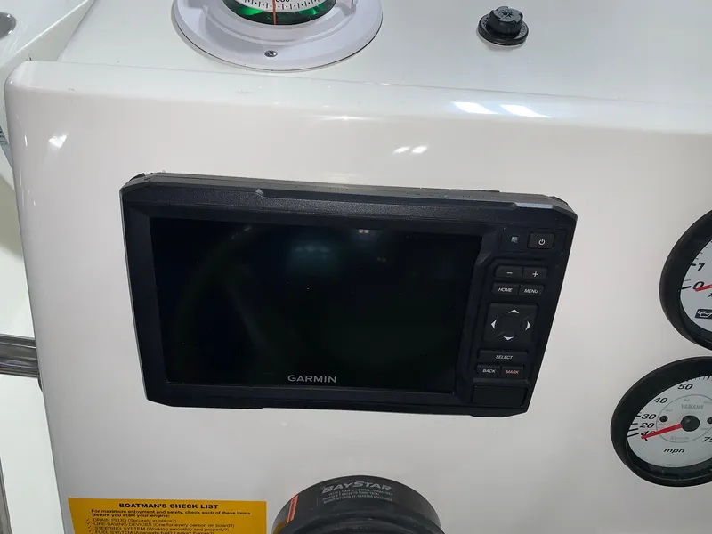 Slide: The Image of Garmin display on 2026 Key West 188 Bay Reef boat dashboard with gauges. - 13