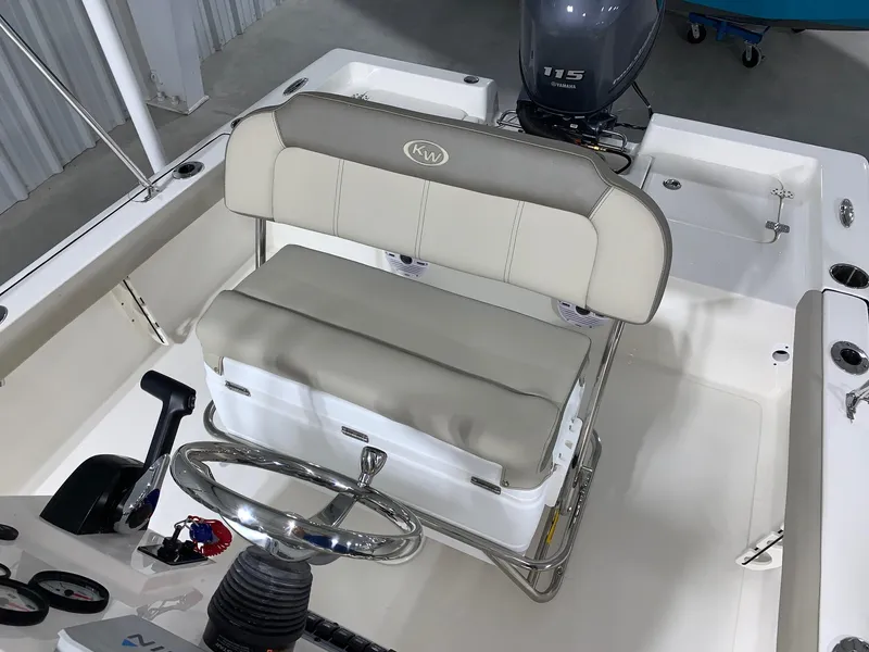 Slide: The Image of 2026 Key West 188 Bay Reef boat interior with steering wheel and cushioned seating. - 15