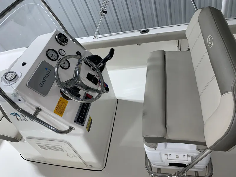 Slide: The Image of 2026 Key West 188 Bay Reef boat interior with steering console and cushioned seating. - 17