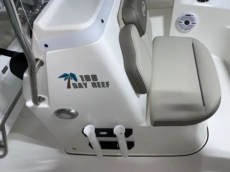 Slide: The Image of 2026 Key West 188 Bay Reef boat interior with cushioned seating and logo. - 20