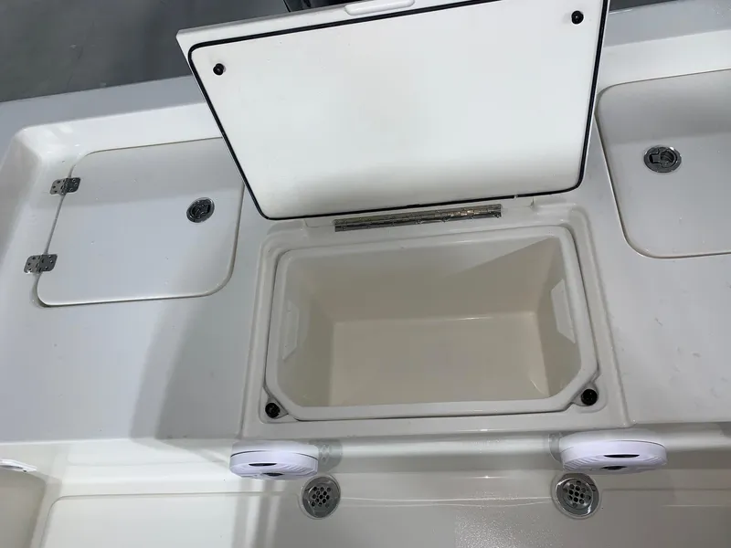 Slide: The Image of Key West 188 Bay Reef 2026 boat storage compartments with open lid, showcasing interior space. - 6