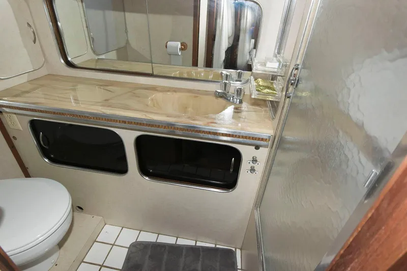 Slide: The Image of 1984 Chris-Craft 350 Catalina bathroom with sink, mirror, and shower. - 15