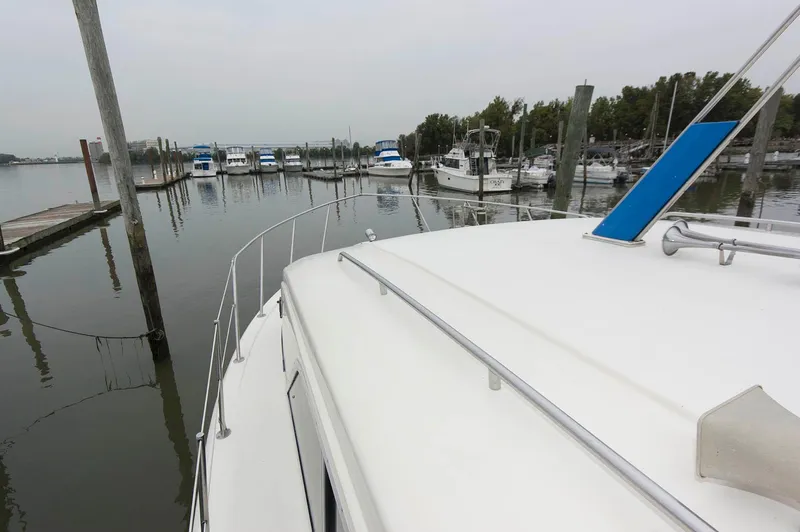 Slide: The Image of 1984 Chris-Craft 350 Catalina yacht docked in a serene marina setting. - 4